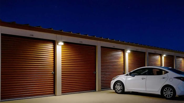 a car parked at a well-lit storage facility at night