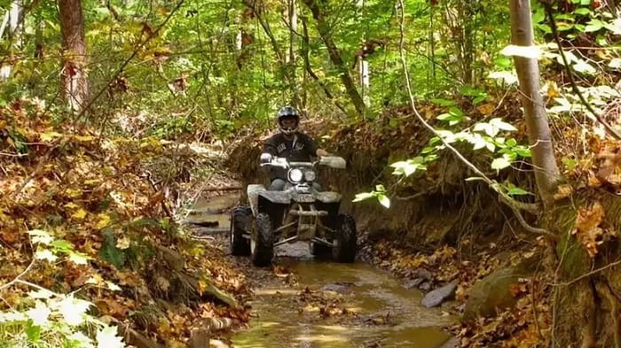 an atv on a muddy trail