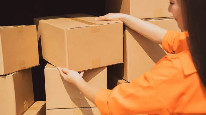 A woman packing away boxes