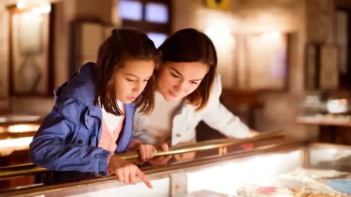 A woman and her daughter are looking at an exhibit in the Atoka Museum and Heritage Centre near Mini Mall Storage
