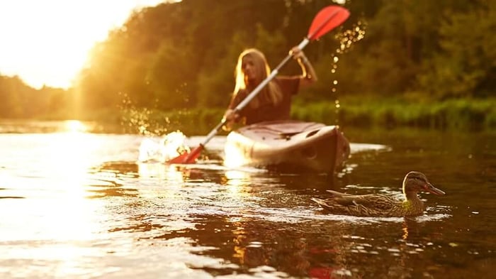 a woman kayaking in a lake 