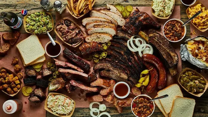 a large spread of BBQ and other foods