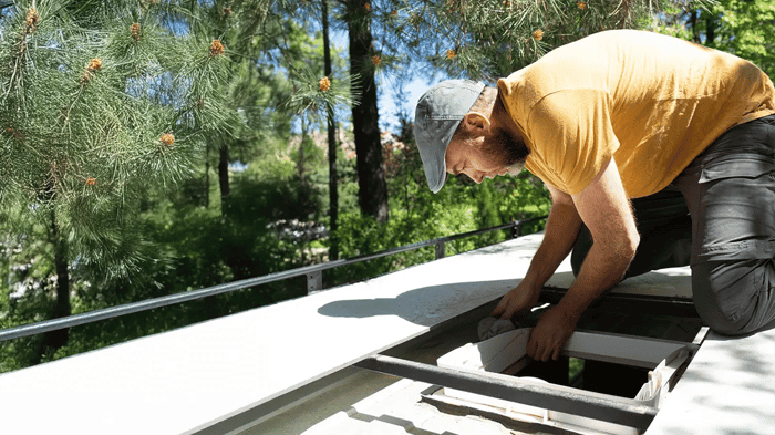 an RV's roof seals being examined 