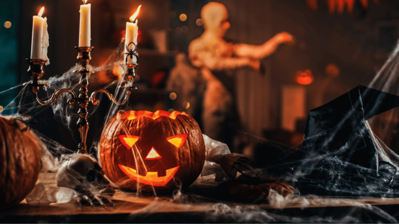 Ceramic pumpkins, candles, and Halloween decorations arranged on a table before packing
