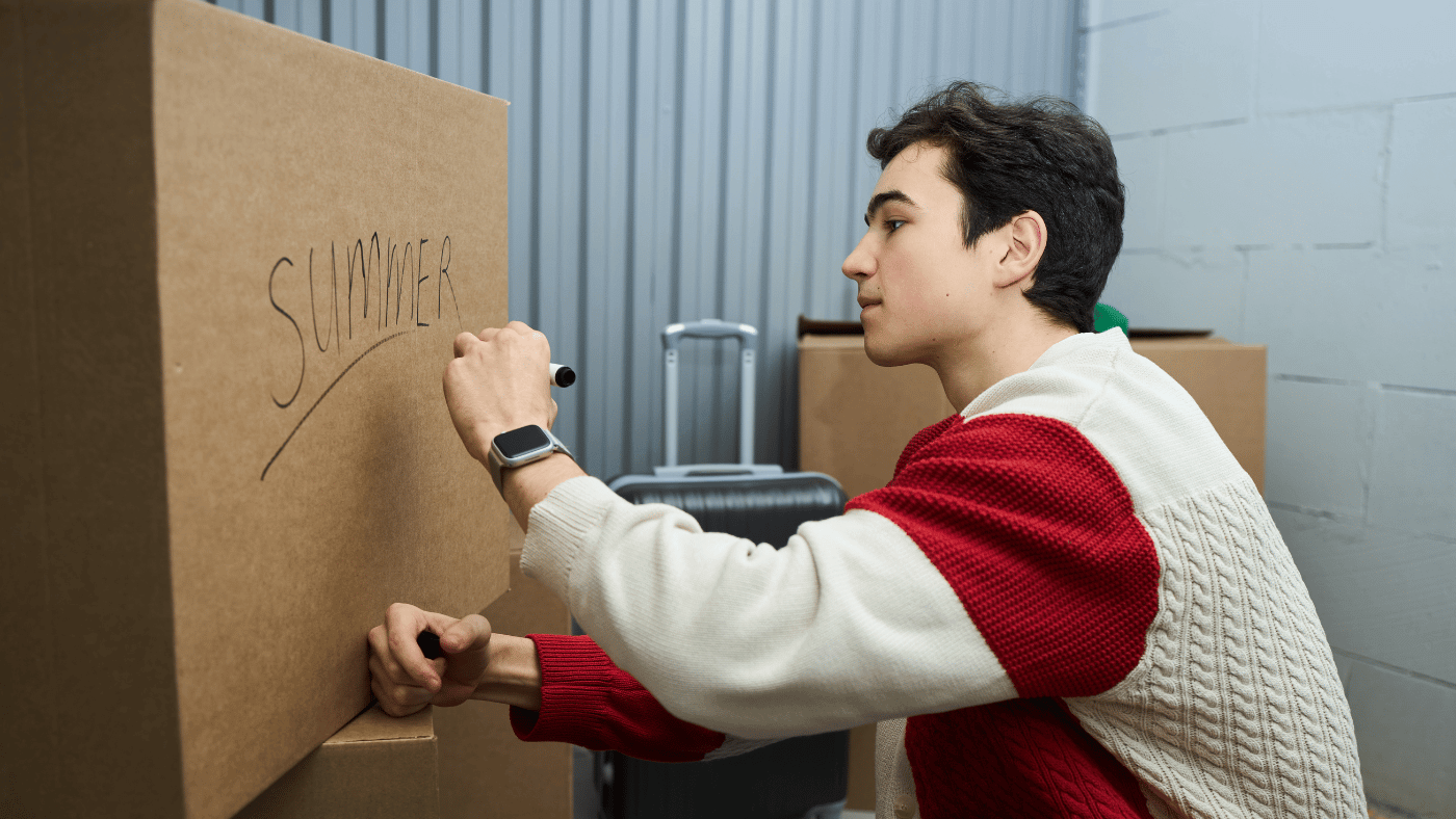 person labeling packed household boxes for off-site storage
