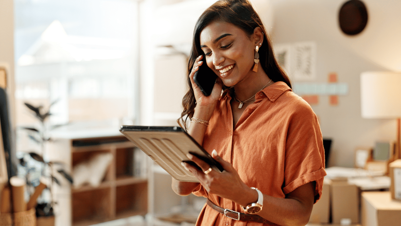 Woman asking questions by phone while reviewing rental information on a tablet