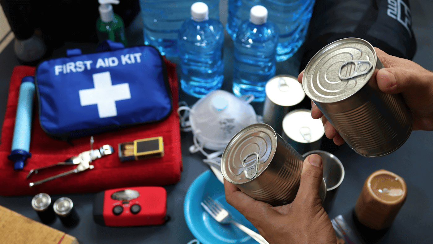 Food, water, flashlights, and first-aid items organized for emergency supply storage